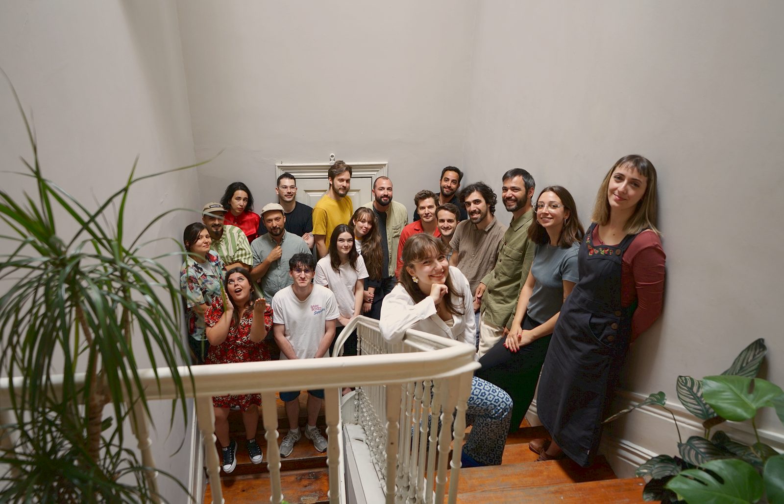 Team photo on a staircase with plants